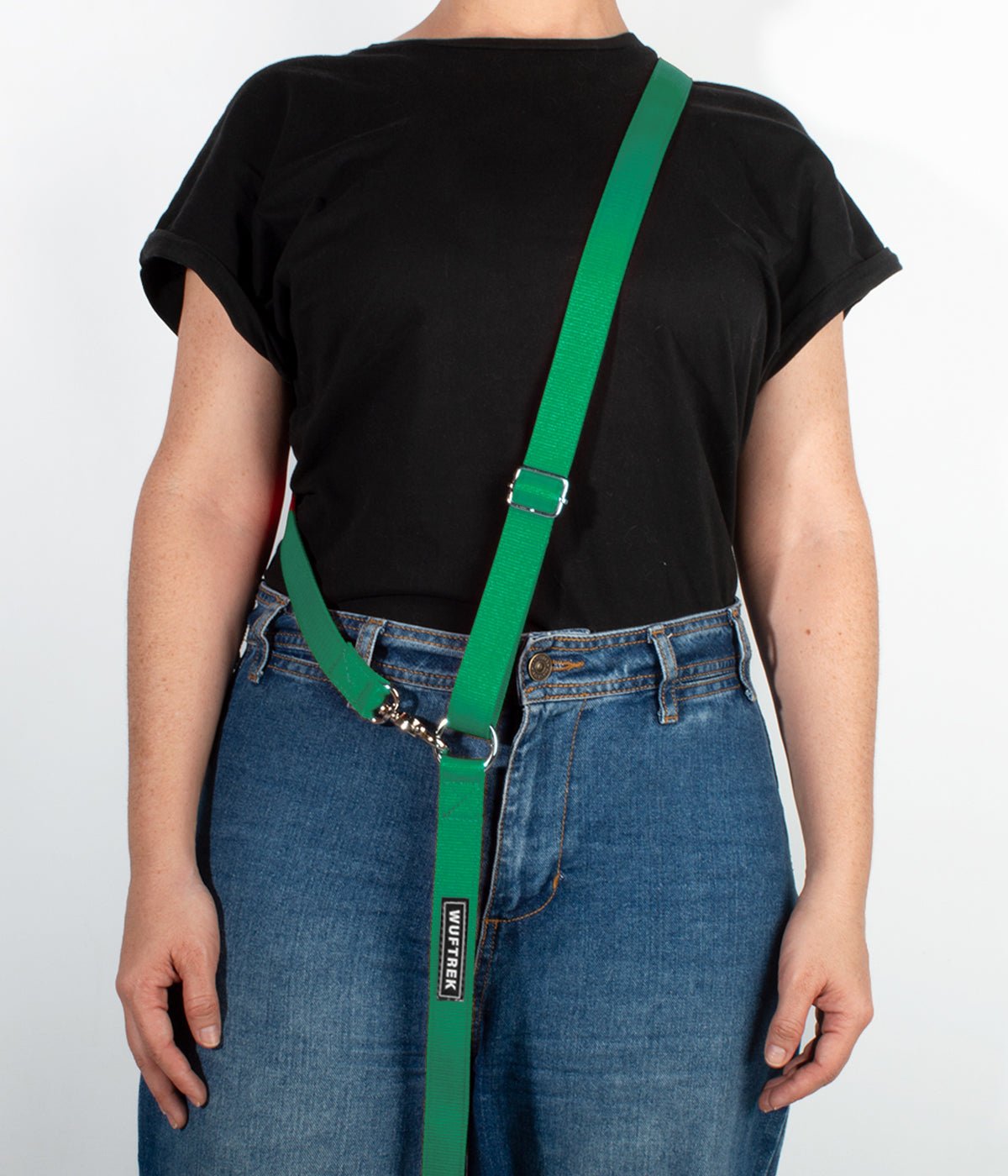 Una mujer usando una correa manos libres para perros color verde