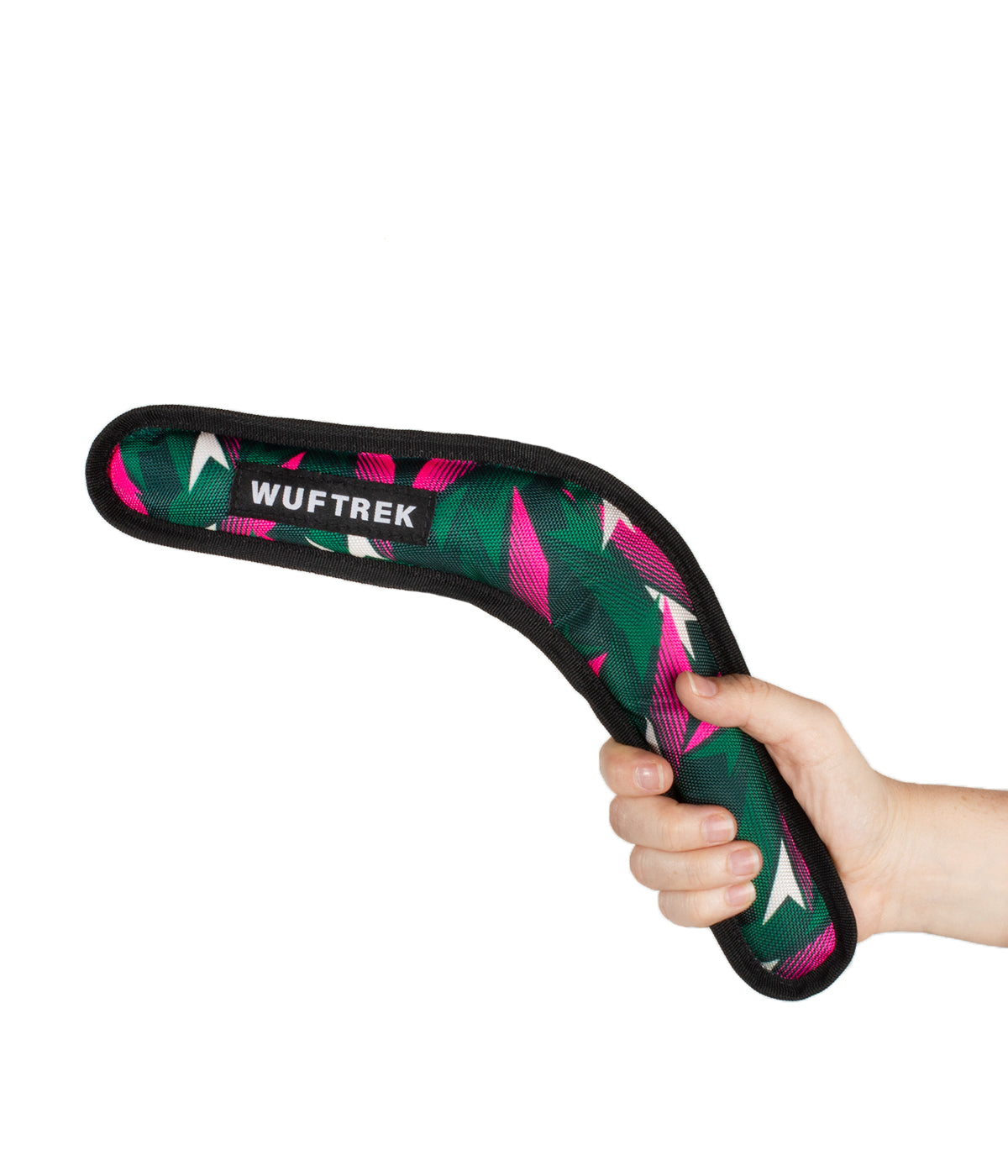 Woman holding a boomerang-shaped dog toy in green and fuchsia