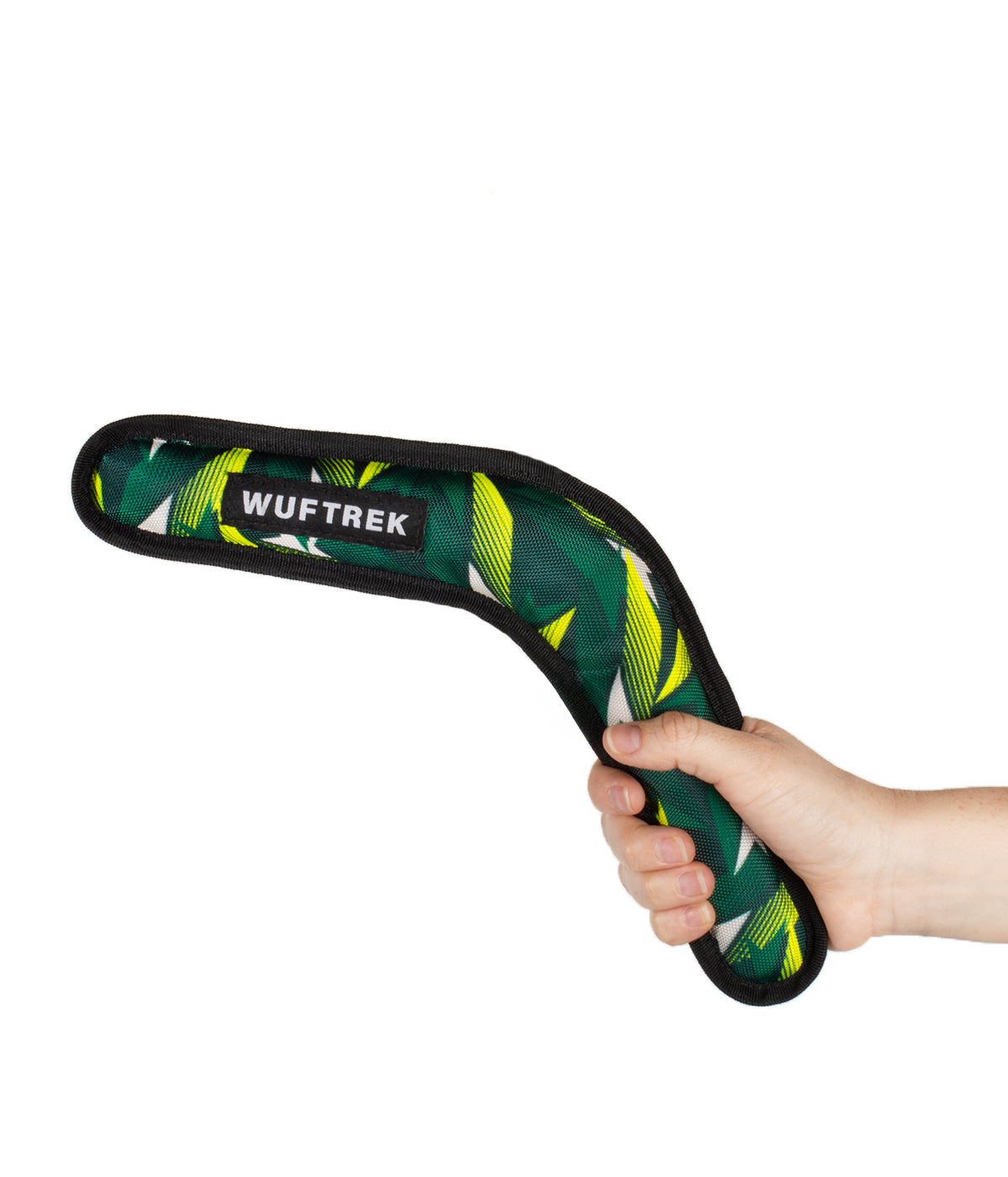 Woman holding a boomerang-shaped dog toy in green and yellow
