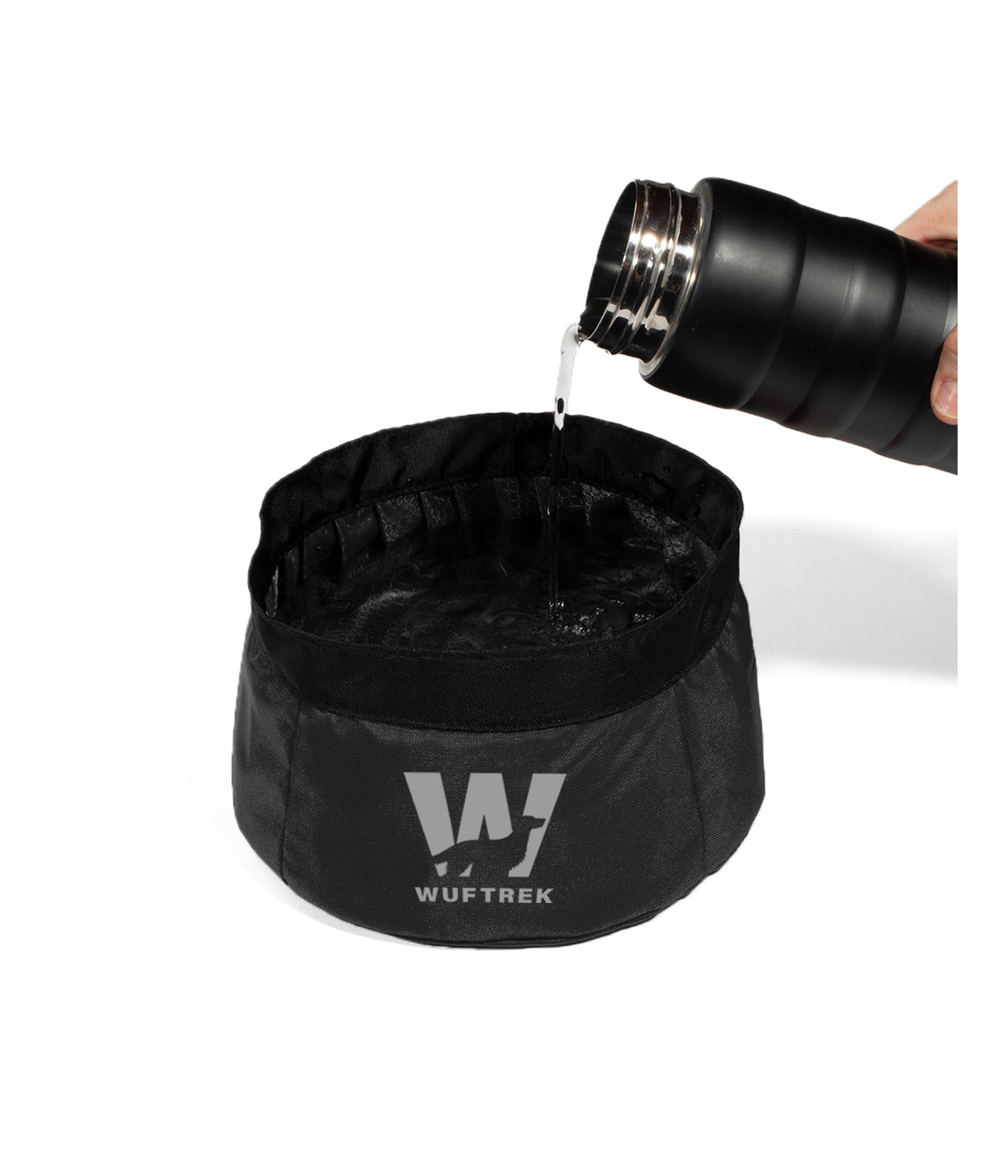 Black TrekBowl dog food and water bowl filled with water