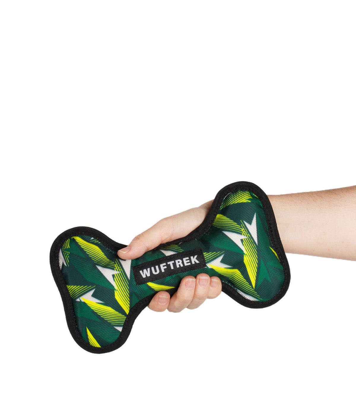 Woman holding a small bone-shaped dog toy in green and yellow
