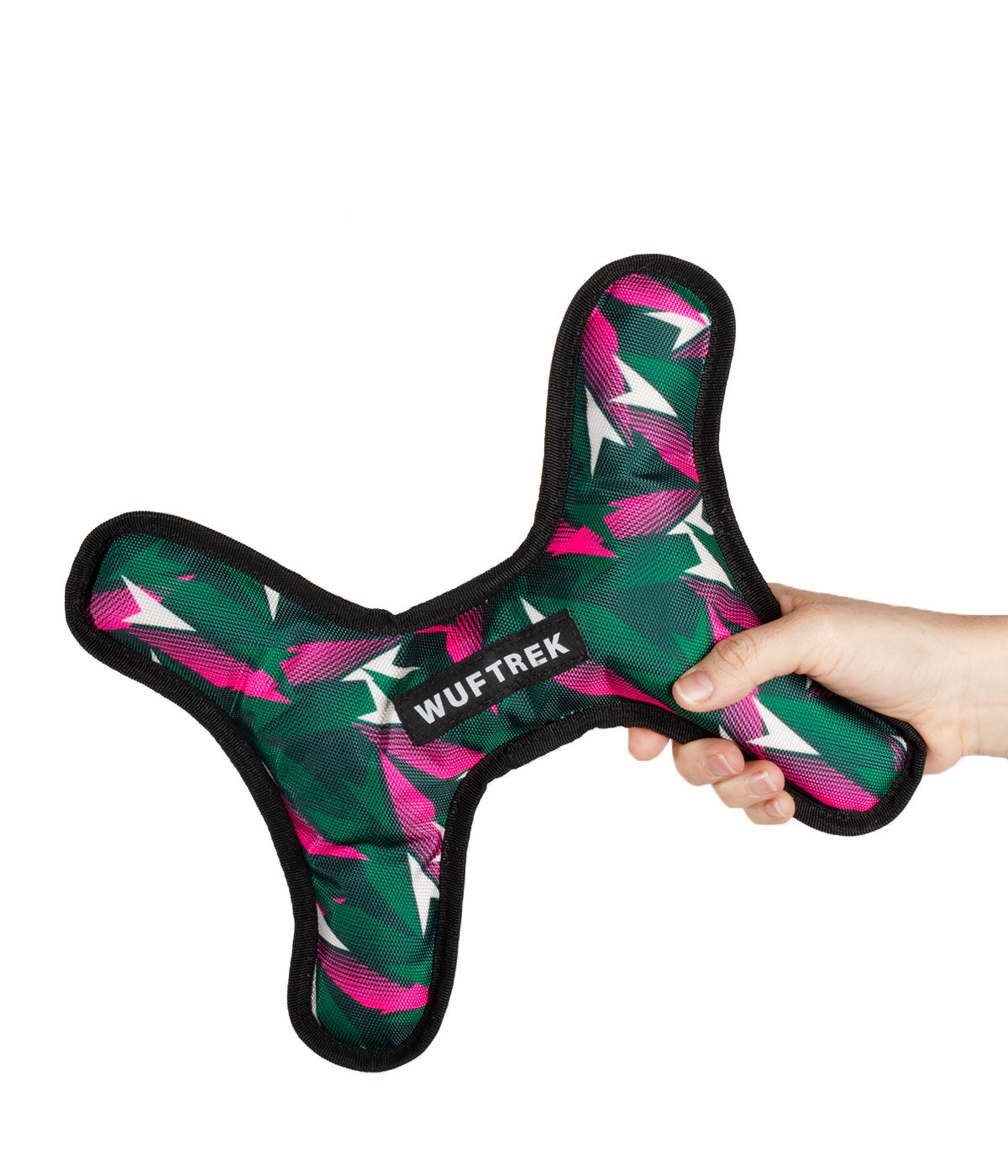 Woman holding a large bone-shaped dog toy in green and fuchsia