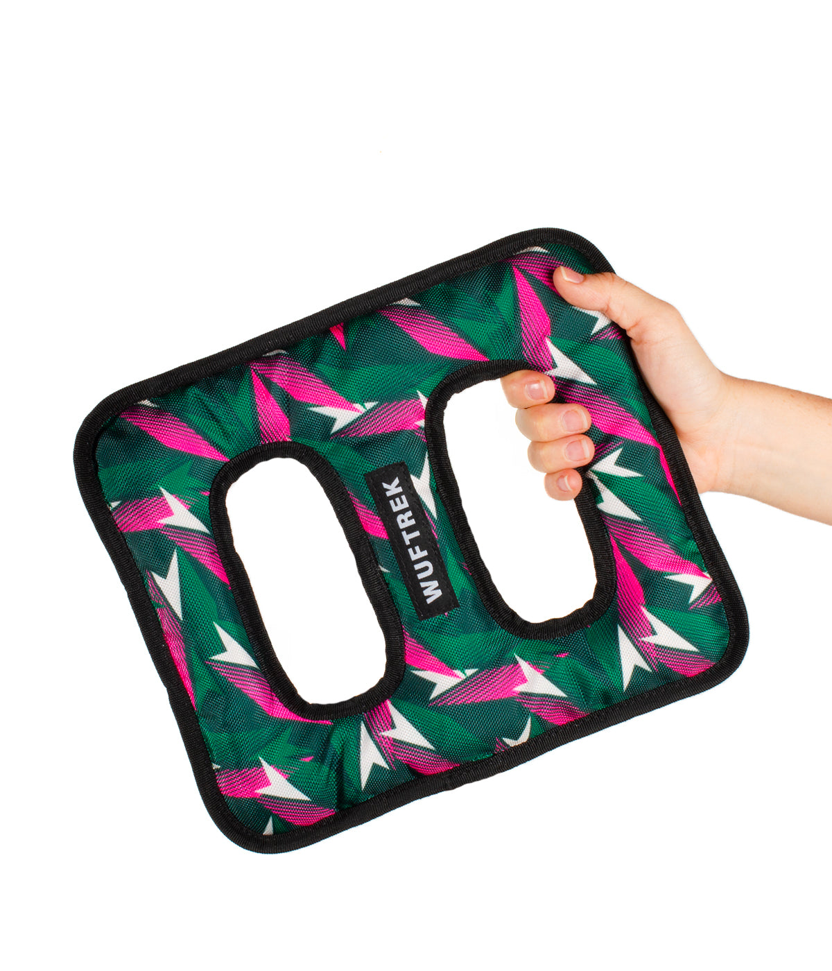 Woman holding a figure-eight-shaped dog toy in green and fuchsia