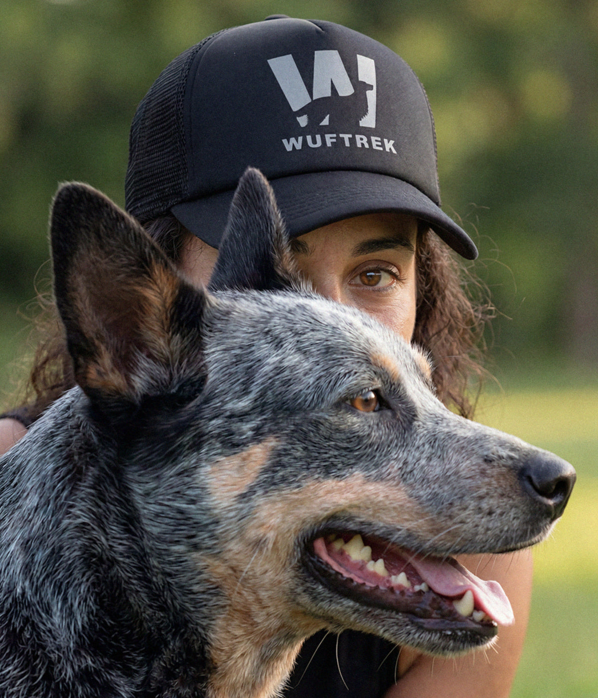 Woman wearing a black WUFTREK Trucker cap
