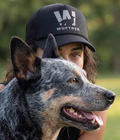 Woman wearing a black WUFTREK Trucker cap